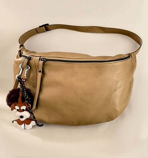 Large beige leather pouch with a zipper and a cute dog charm accessory.